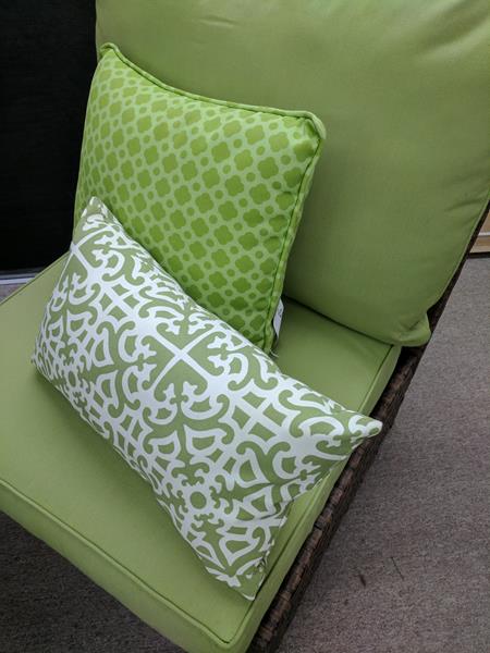 green chair with pillows
